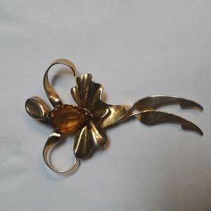 Stylistic brooch 1970s amber colored stone